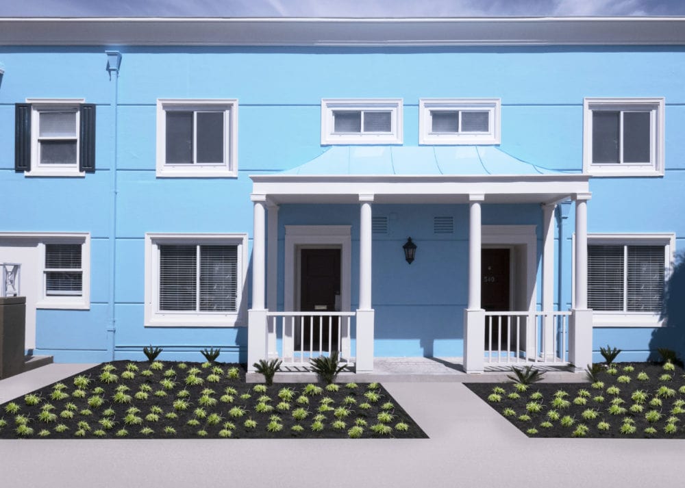 Bright blue facade of Arballo collection townhomes