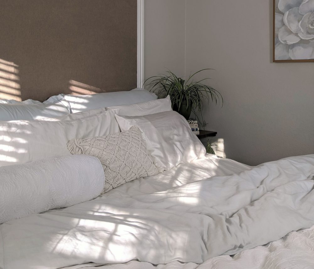 Bed with rumpled white bedding