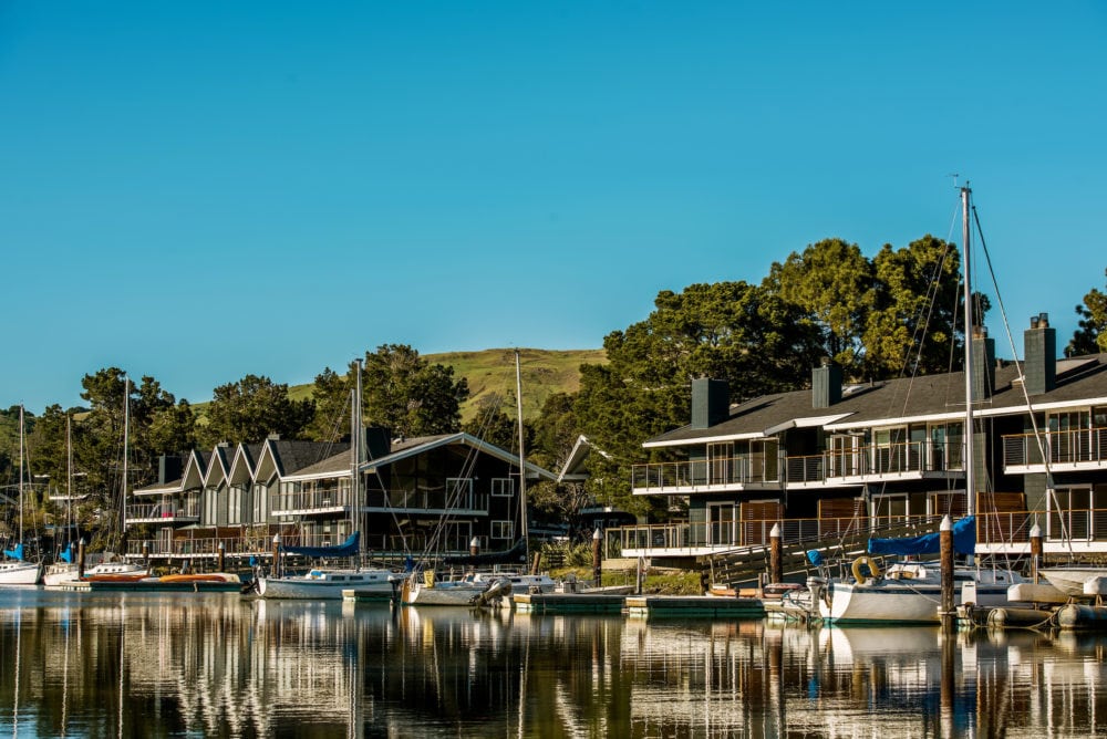 The Cove at Tiburon apartments and docked boats, viewed from water