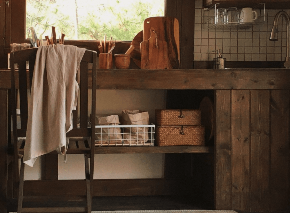 farmhouse style kitchen counter with baskets and breadboards